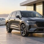 Graphite SUV and white sedan outside a modern building